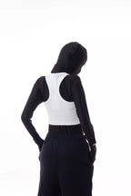 Person wearing a white Athletica Muscle Tee Tank