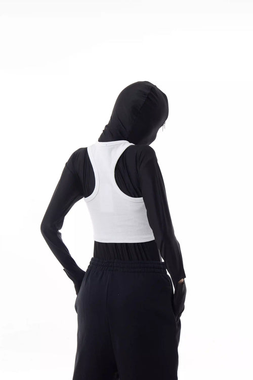 Person wearing a white Athletica Muscle Tee Tank