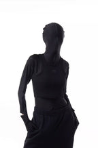 Person wearing a black Athletica Muscle Tee Tank