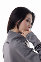 Woman wearing a gray Core Zip Up