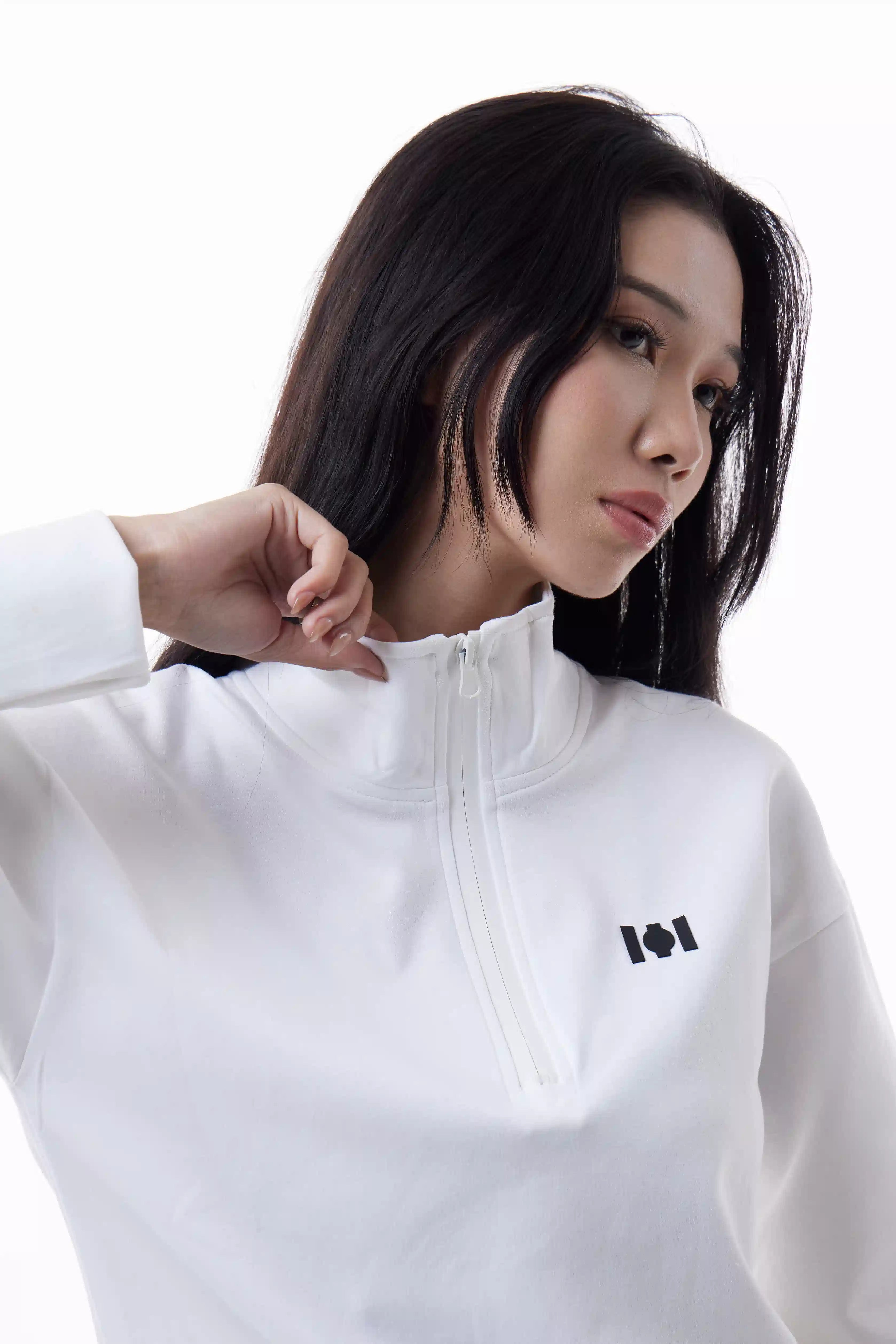 Woman wearing a white Core Zip Up