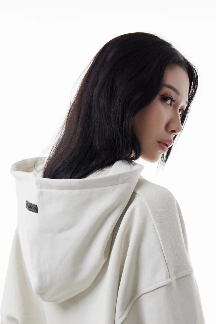 Woman wearing a white Elevated Hoodie