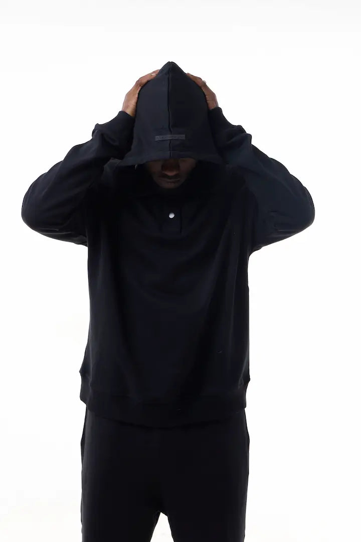 Man wearing a black Elevated Hoodie
