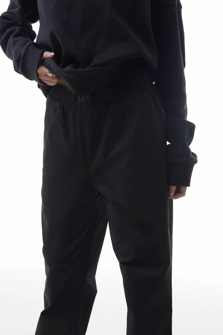 Person wearing black elevation pants