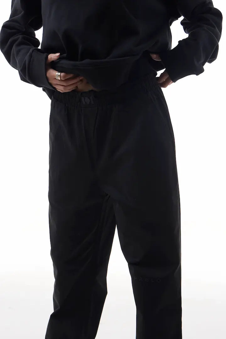 Person wearing black elevation pants