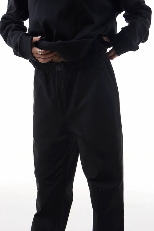 Person wearing black elevation pants