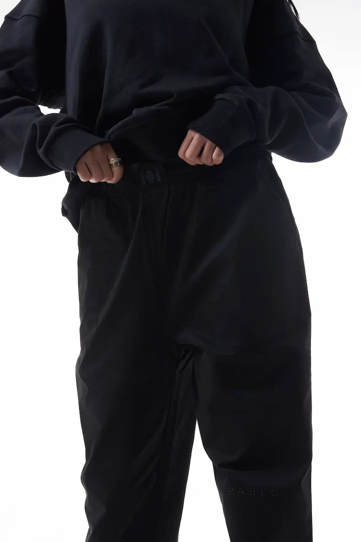 Person wearing black elevation pants