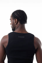 Man wearing a black Power Muscle Tee Tank