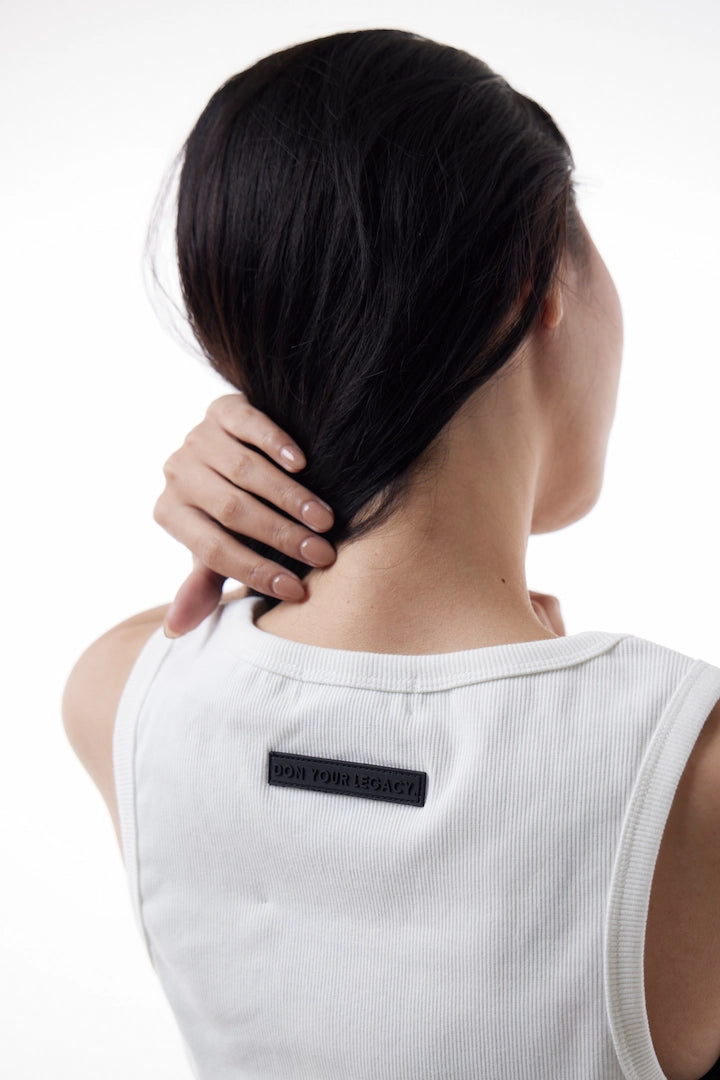 Woman wearing a white Power Muscle Tee Tank