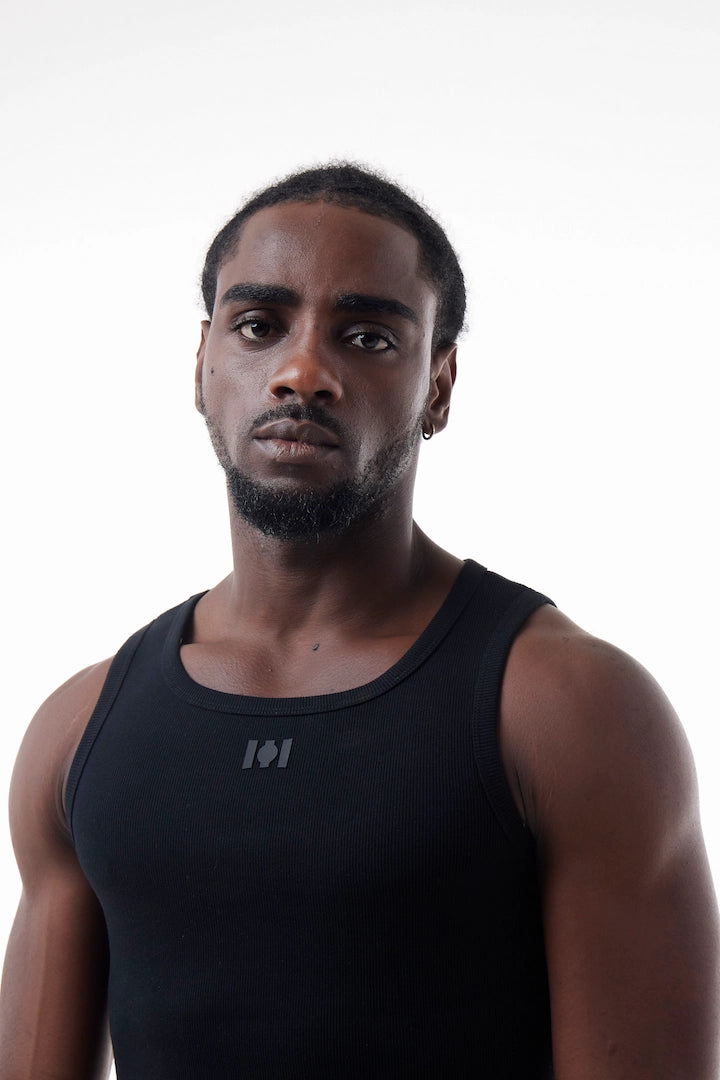 Man wearing a black Power Muscle Tee Tank