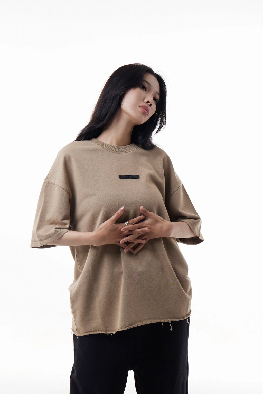 Woman wearing a khaki Raw Edge Tee