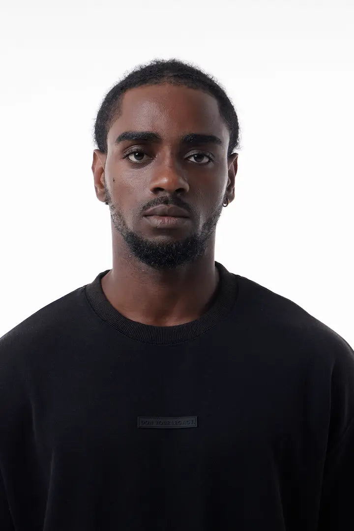 Man wearing a black Raw Edge Tee