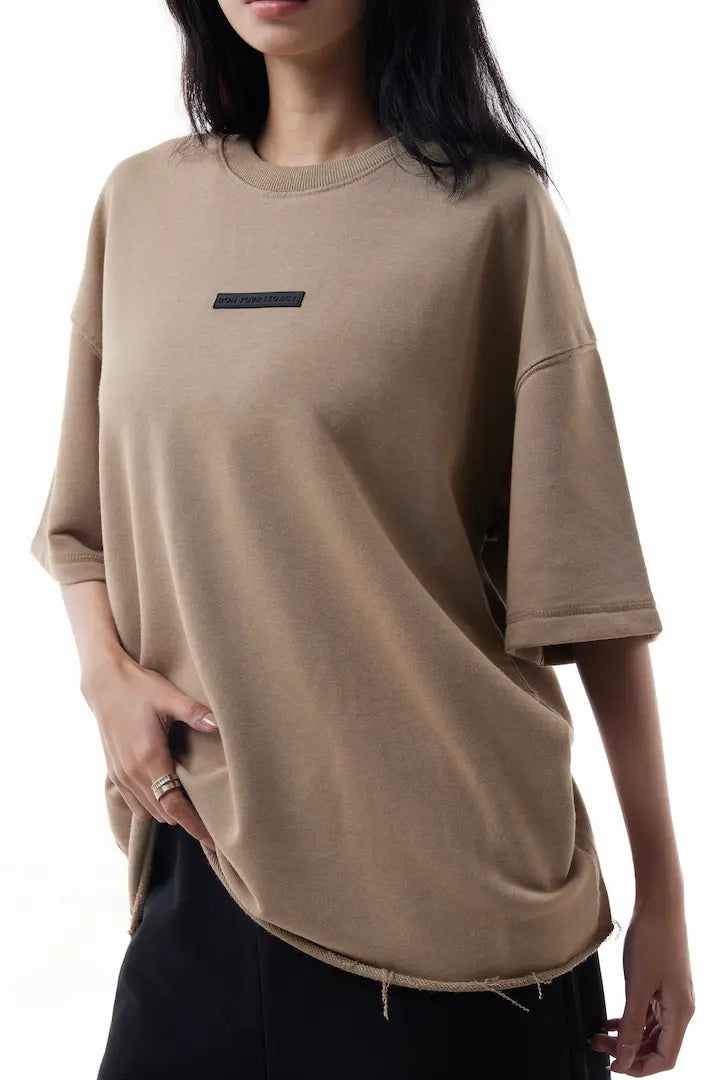 Woman wearing a khaki Raw Edge Tee