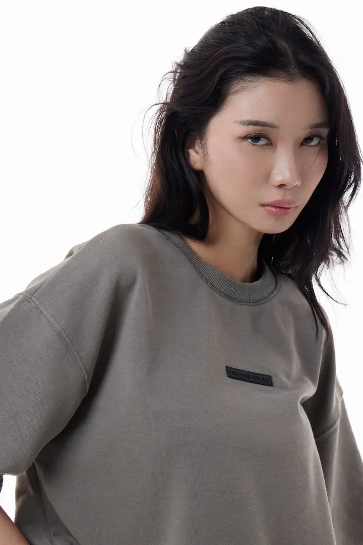 Woman wearing a gray Raw Edge Tee