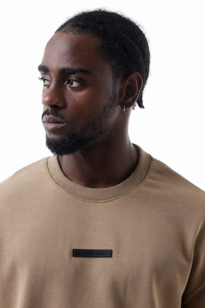 Man wearing a khaki Raw Edge Tee