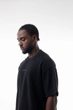 Man wearing a black Raw Edge Tee