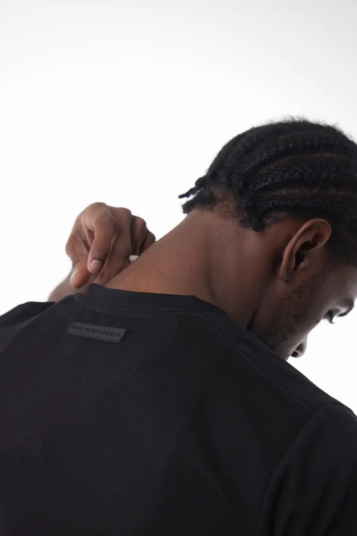Man wearing a black The Base Tee