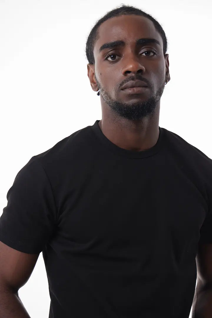 Man wearing a black The Base Tee