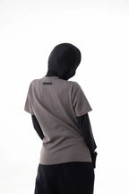Person wearing a gray The Base Tee