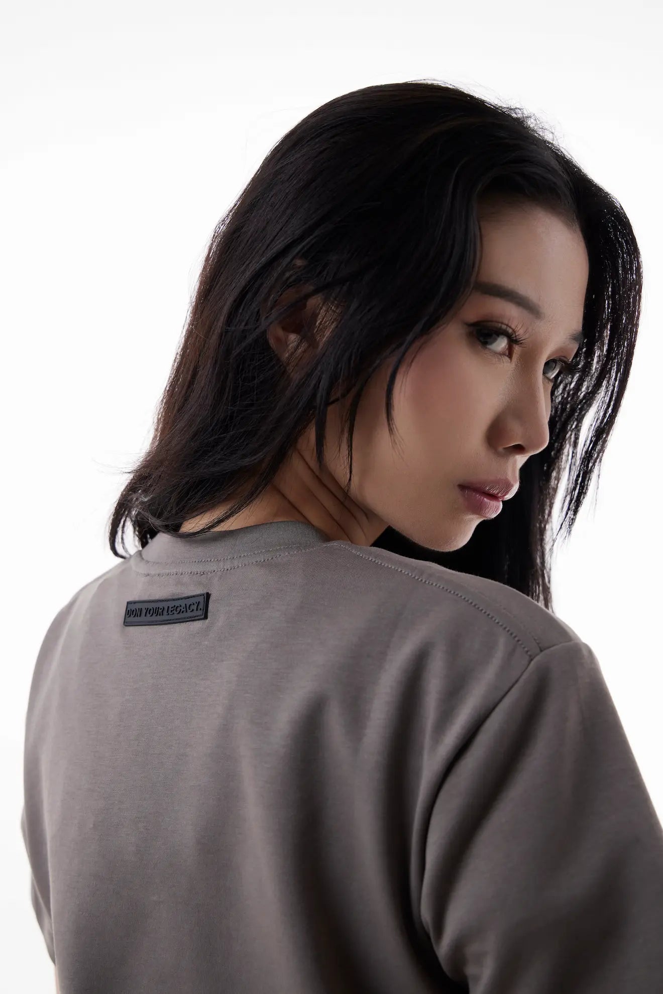 Woman wearing a gray The Base Tee