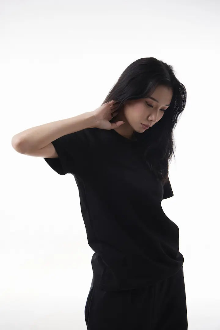 Woman wearing a black The Base Tee