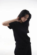 Woman wearing a black The Base Tee