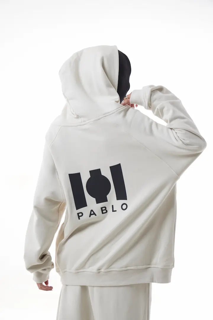 Woman wearing a white Essential Hoodie