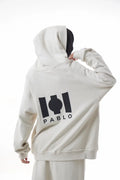 Woman wearing a white Essential Hoodie