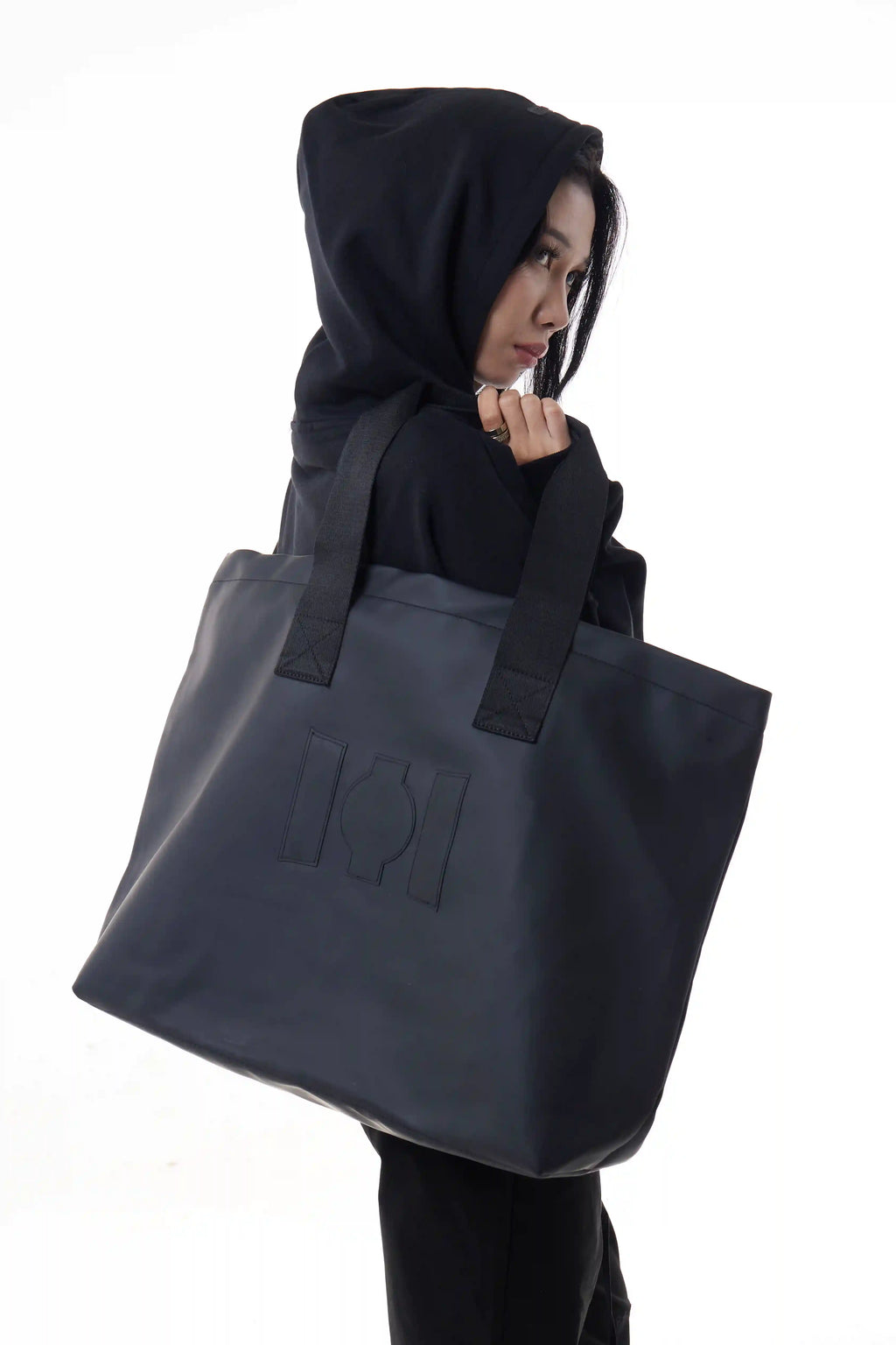Woman holding a black Urban Tote