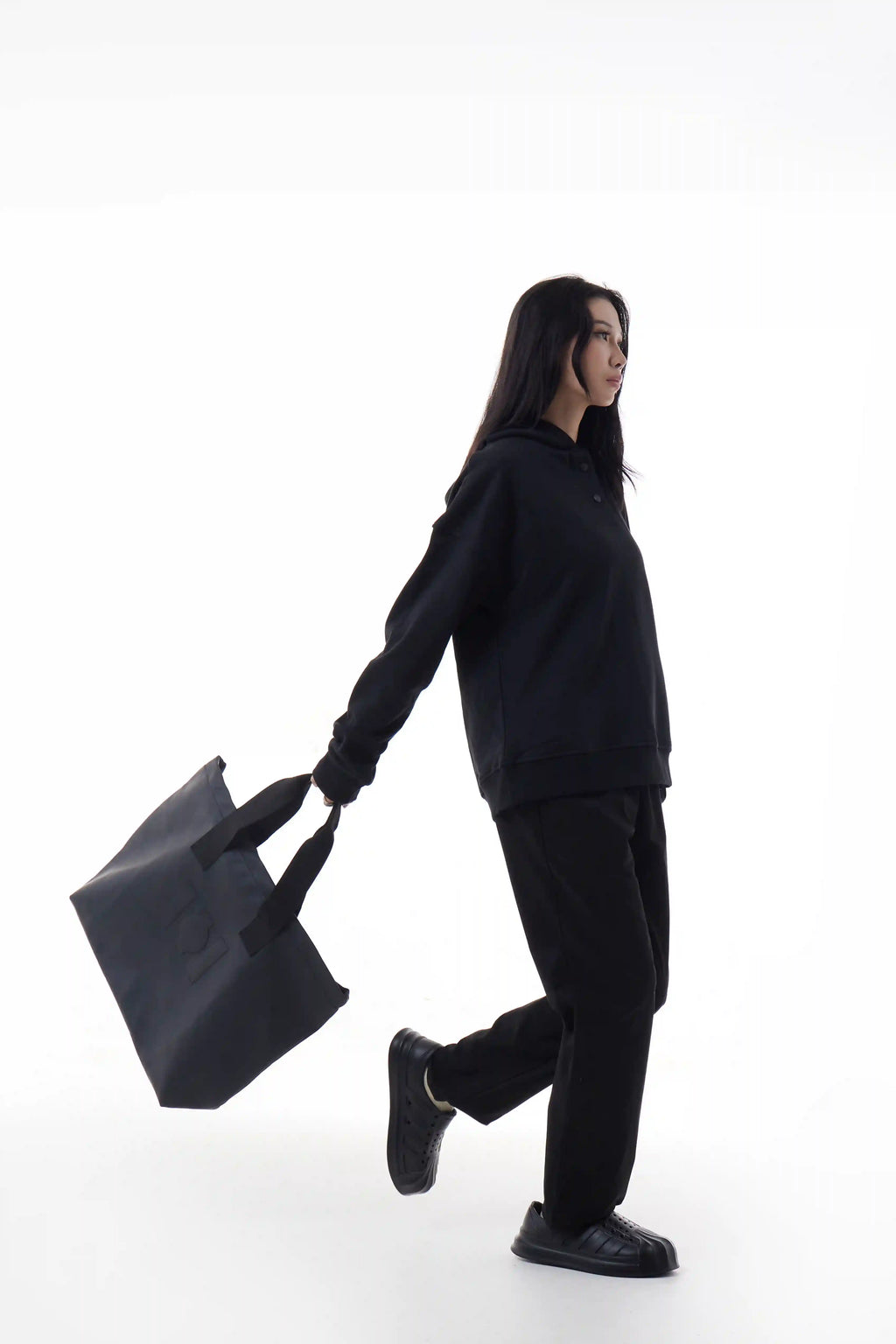Woman holding a black Urban Tote