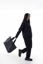 Woman holding a black Urban Tote