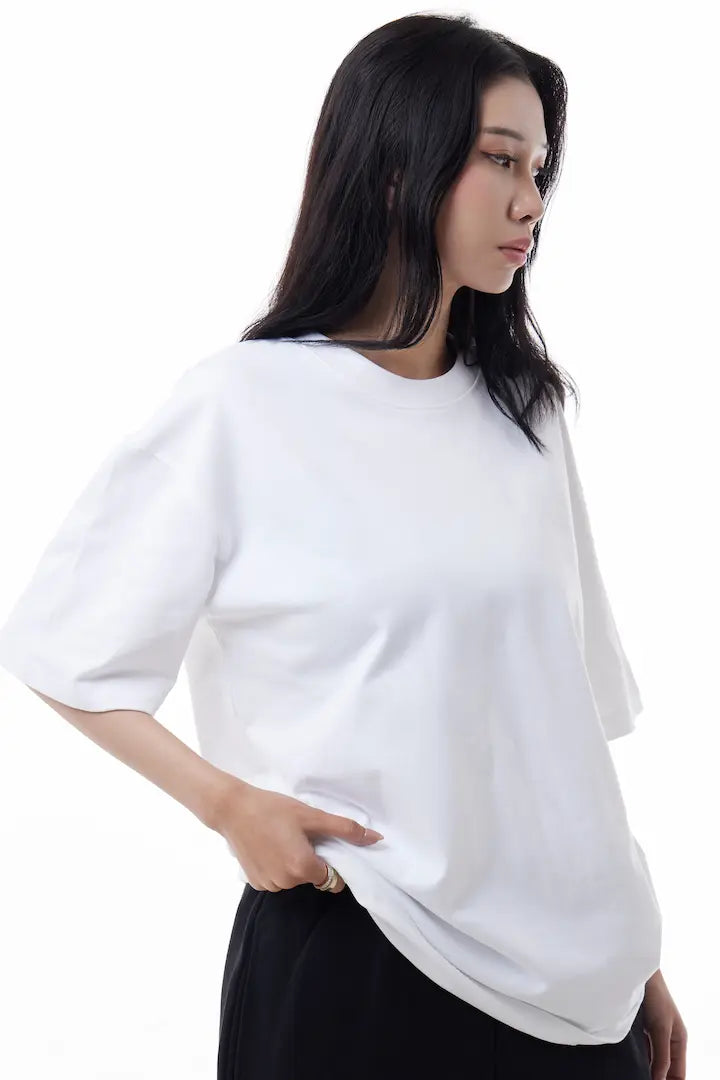 Woman wearing a white Vibe Drift Tee