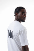 Man wearing a white Vibe Drift Tee