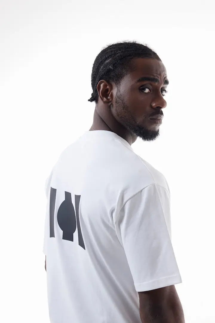 Man wearing a white Vibe Drift Tee
