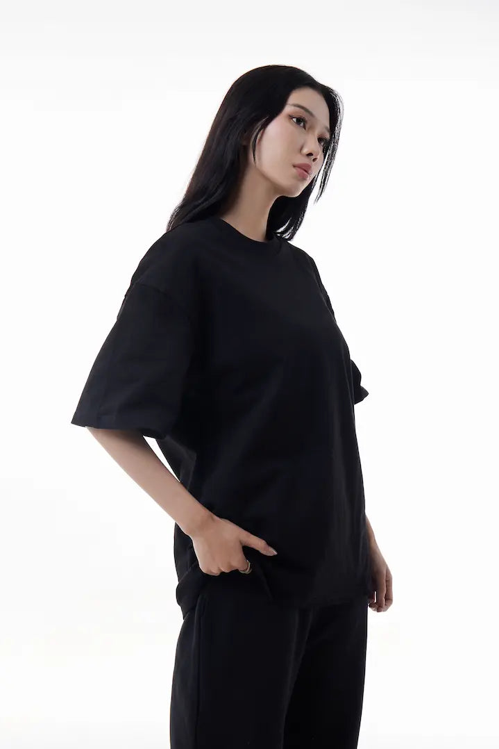 Woman wearing a black Vibe Drift Tee