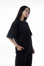 Woman wearing a black Vibe Drift Tee